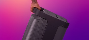 Image of XP700 X-Series Portable speaker with a hand gripping the comfortable handle on the rear of the speaker.