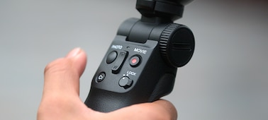 Bluetooth shooting grip in someone's hand