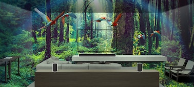 Composite image of a living room with sofa and surround sound system within a lush jungle setting.