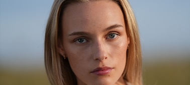 Example image showing a close-up portrait of a woman’s face, looking straight at the camera